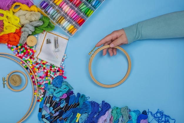 hands sewing colorful embroidery hoop